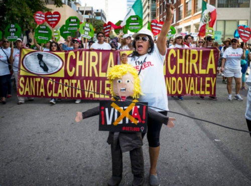Hundreds of May Day marchers chanting slogans and carrying signs - and one carrying a Donald Trump - take to the streets of Los Angeles, calling for immigrant and worker rights and decrying what they see as hateful presidential campaign rhetoric, Sunday, May 1, 2016. It's one of several events in cities nationwide to call for better wages for workers, an end to deportations and support for an Obama administration plan to give work permits to immigrants in the country illegally whose children are American citizens.(David Crane/Los Angeles Daily News via AP) LA TIMES OUT VENTURA COUNTY STAR OUT